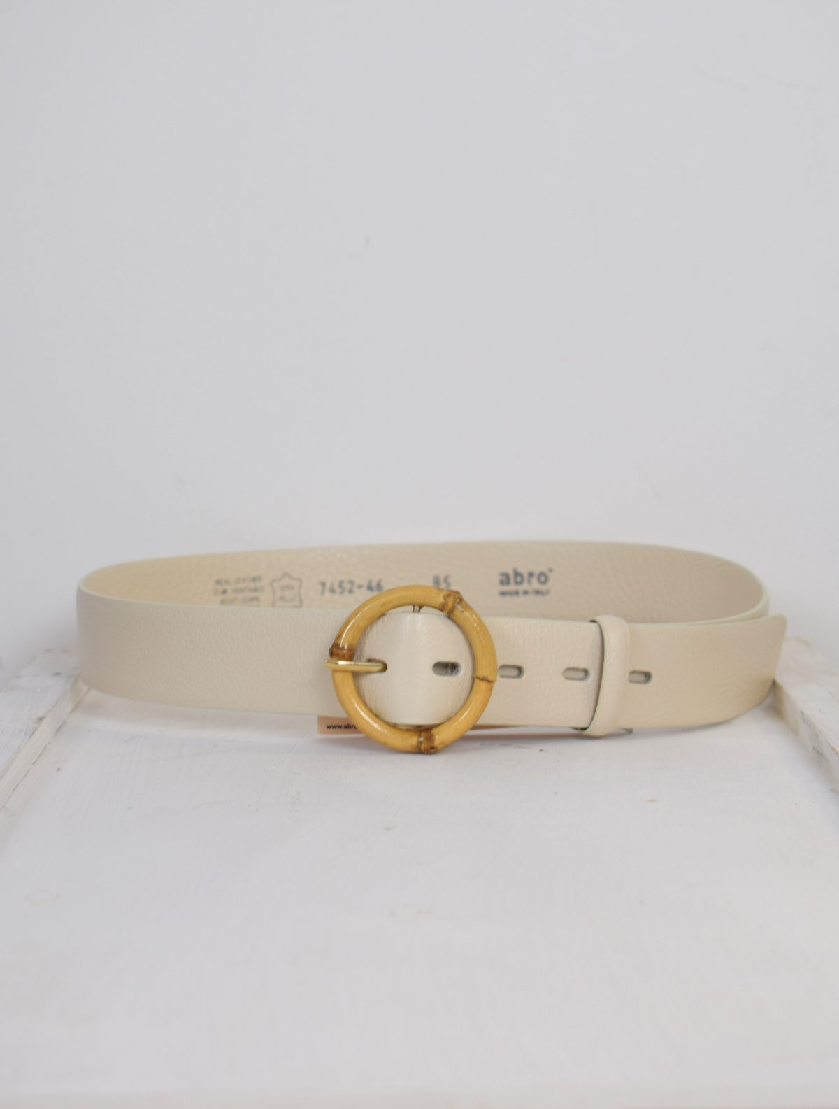 Cream belt with circular buckle 