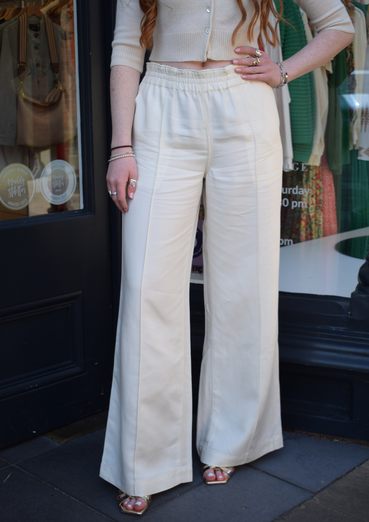Long white, elasticated waist trousers with seam down the front 