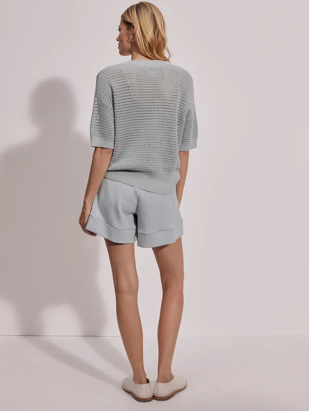 Short sleeve knitted honeycomb top with notch neckline and aesthetic buttons in a light sage green