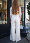 Long white, elasticated waist trousers with seam down the front 