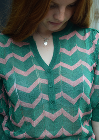 A green sparkly top with pink shevron zigzag