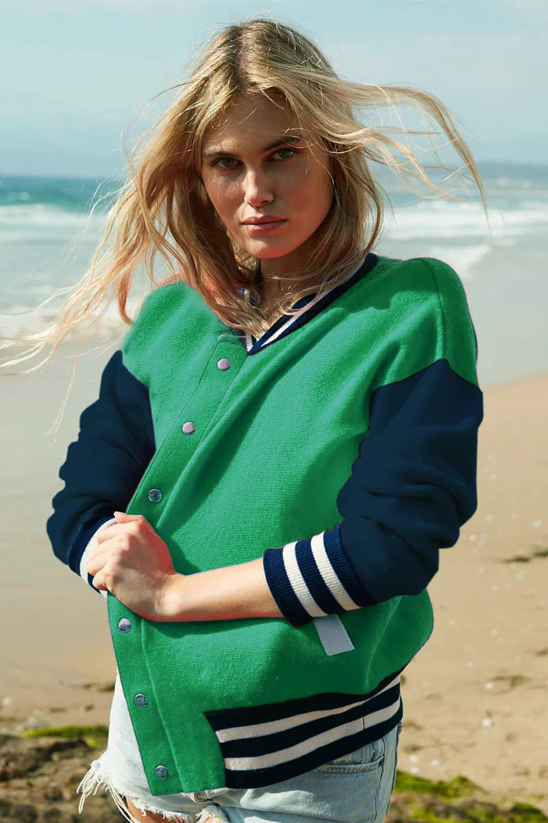 Knitted green bomber jacket with navy sleeves and white details with silver popper closures