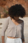 Cropped cashmere beige cardigan with V neckline button fastening and three quarter length sleeves