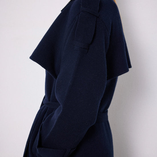 Side view of navy knitted trench