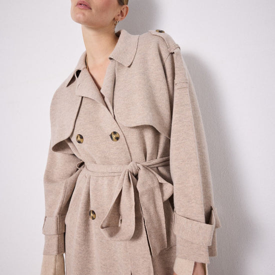 Beige knitted trench coat on model