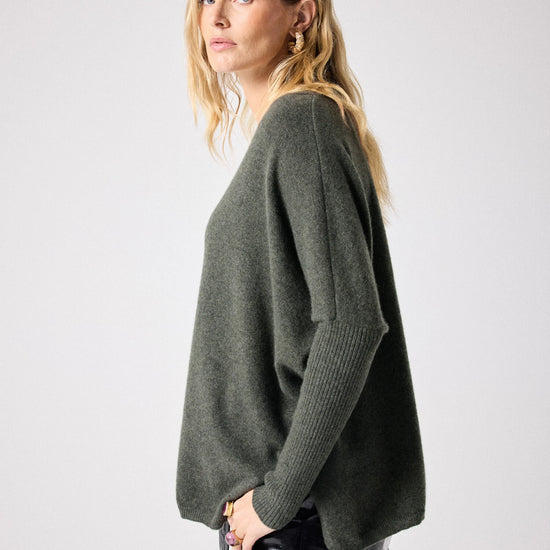 Side view of Dark green deep V cashmere knit with boxy fit