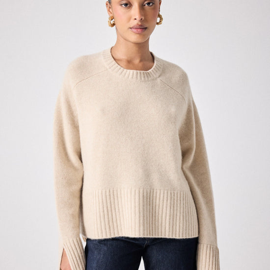 beige cashmere knit with ribbed neck and split cuffs 