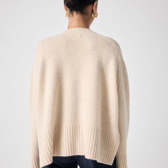 beige cashmere knit with ribbed neck and split cuffs  rear view