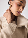 beige cashmere knit with ribbed neck and split cuffs  close up