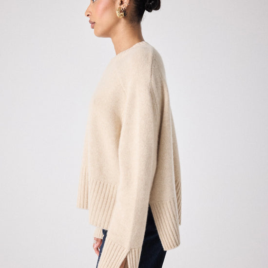 beige cashmere knit with ribbed neck and split cuffs  side view