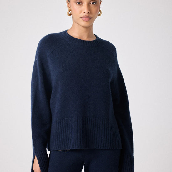 navy cashmere knit with round ribbed neck and split cuffs  model shot