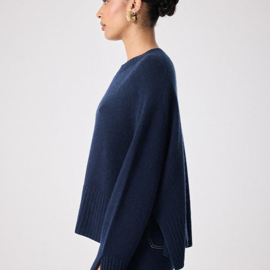 navy cashmere knit with round ribbed neck and split cuffs  side view 