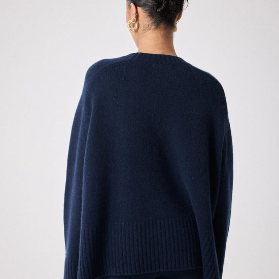 navy cashmere knit with round ribbed neck and split cuffs  rear view 