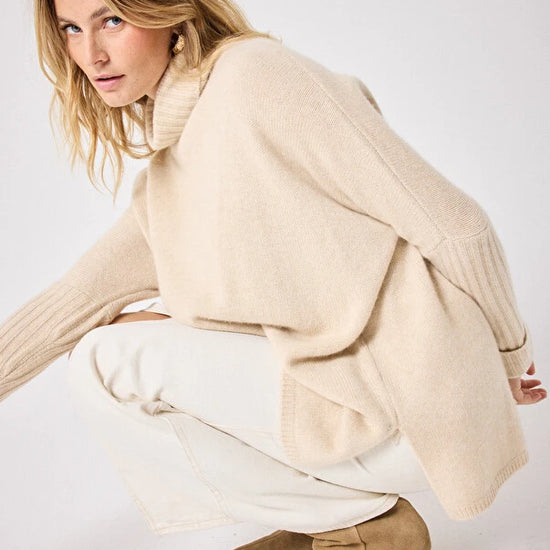 long sleeved roll neck beige jumpe