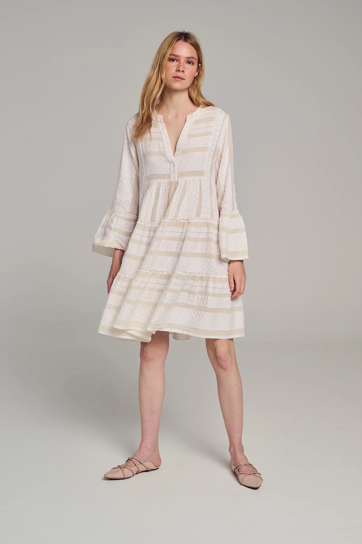 Ecru and off white beach dress knee length with tiered skirt notch neck and flared long sleeves