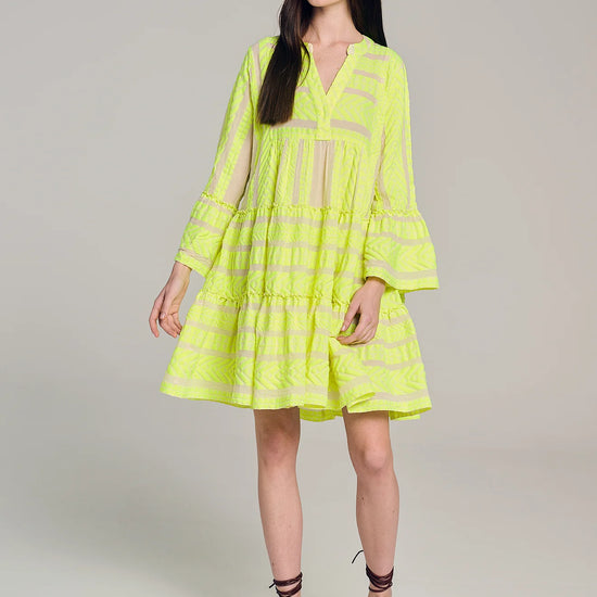 Ecru notch neck above the knee dress with long fluted sleeves and tripe tiered A line skirt with neon lime embroidery throughout