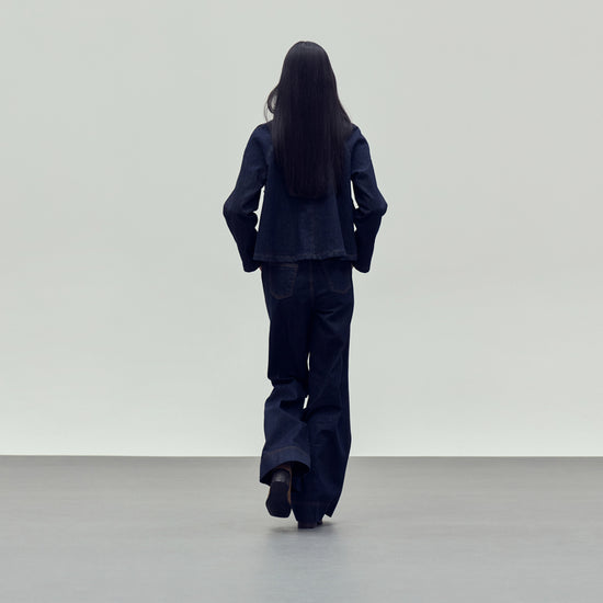 dark blue denim jacket with brown collar rear view