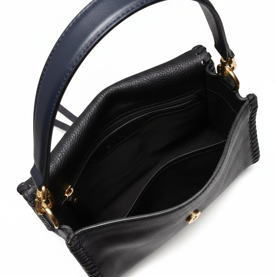 navy leather handbag with gold toned hardwear