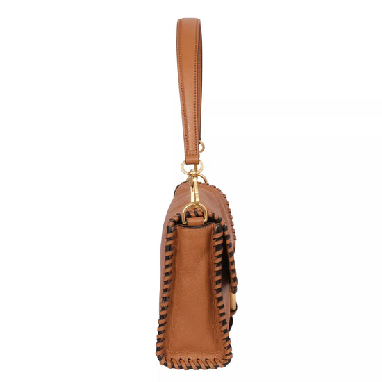 Side view of the tan leather bag with top handle