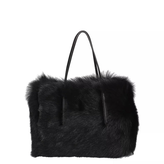 black rectangular small shearling bag with a small top handle and removable cross body strap from abro 