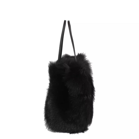 black rectangular small shearling bag with a small top handle and removable cross body strap from abro side view