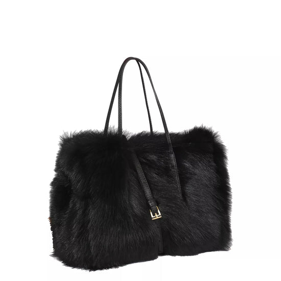 black rectangular small shearling bag with a small top handle and removable cross body strap from abro side view
