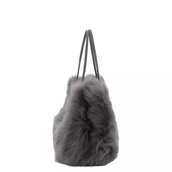 charcoal grey small shearling bag with small top handle and removable crossbody strap from abro side view