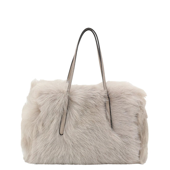 light silvery grey rectangular small shearling bag with small top handle and removable cross body strap from abro