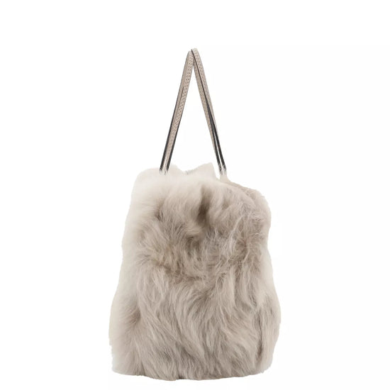 light silvery grey rectangular small shearling bag with small top handle and removable cross body strap from abro side view