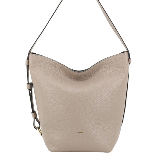 A light beige pebbled leather hobo shoulder bag with a thin dark strap and a small gold logo on the front, shown against a plain white background.