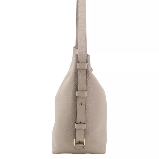 A light taupe pebbled leather shoulder bag shown from the side profile against a solid white background.