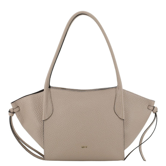 A light taupe pebbled leather handbag with a structured, fan-shaped silhouette, dual top handles, and a thin shoulder strap, shown against a plain white background.