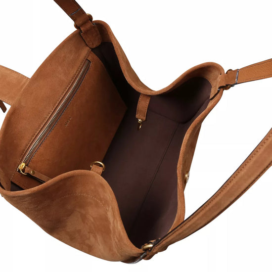 tan suede shopper bag with strap to close the bag inside 