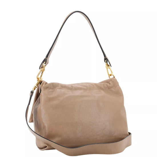 A taupe leather shoulder bag with a black leather strap and gold-tone hardware, shown against a plain white background.