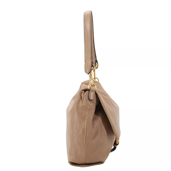 A taupe leather shoulder bag with a drawstring top and gold-tone hardware, shown from a side profile on a white background.