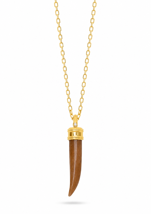 A gold chain necklace featuring a curved brown pendant with a gold cap, displayed against a solid white background.