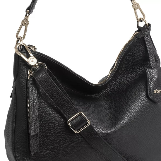 black curved moonshape leather bag with top handle close up