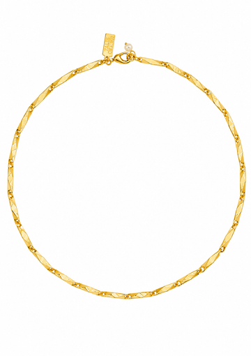 A close-up of a gold chain necklace with a textured, diamond-patterned center and small raised gold dots along the edges, shown against a plain white background.