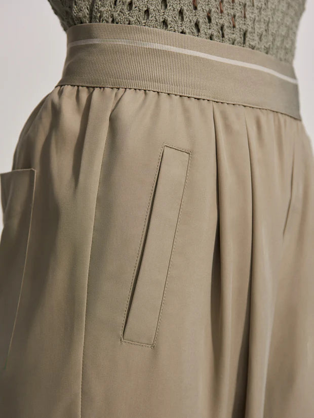 Close up of waistband and side pockets of loose fitting trousers