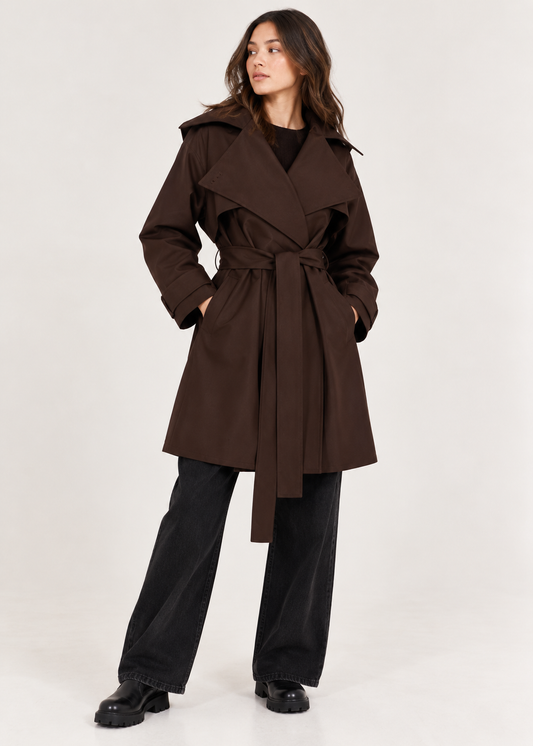 model shown wearing a brown short trench coat and black jeans 