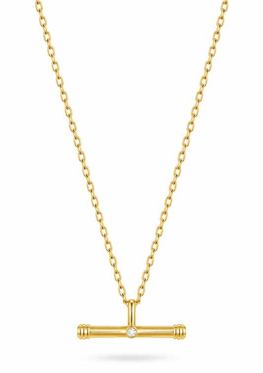 A gold chain necklace with a T-bar pendant featuring a small central clear gemstone, shown on a clean white background.