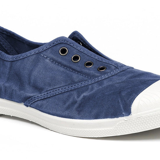 Faded navy canvas shoe with white rubber sole and toe