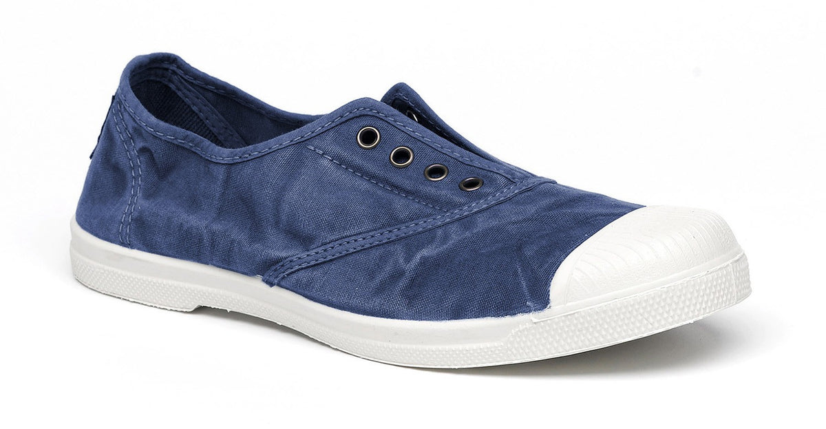 Faded navy canvas shoe with white rubber sole and toe