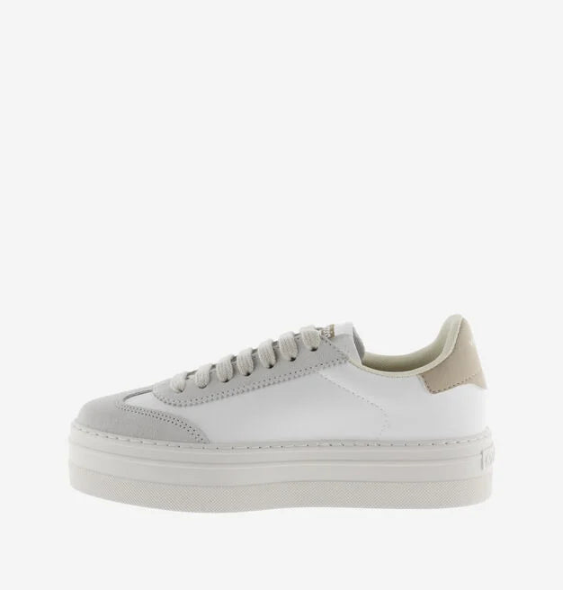 white platform trainers with beige suede v on side  side view