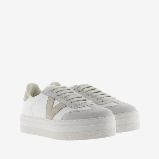 white platform trainers with beige suede v on side front view