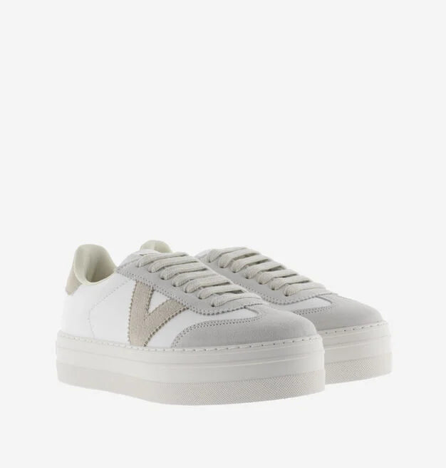 white platform trainers with beige suede v on side front view