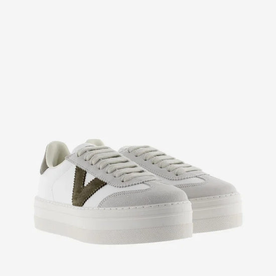 white platform trainers with green suede v on side from victoria front view