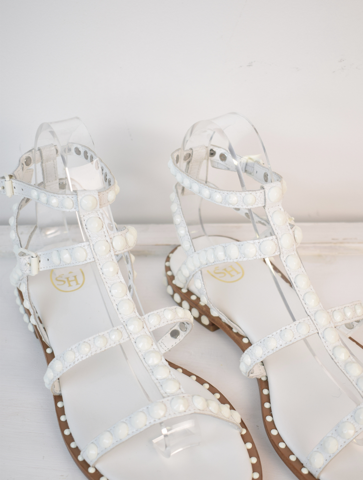 White studded gladiator sandals with tan sole