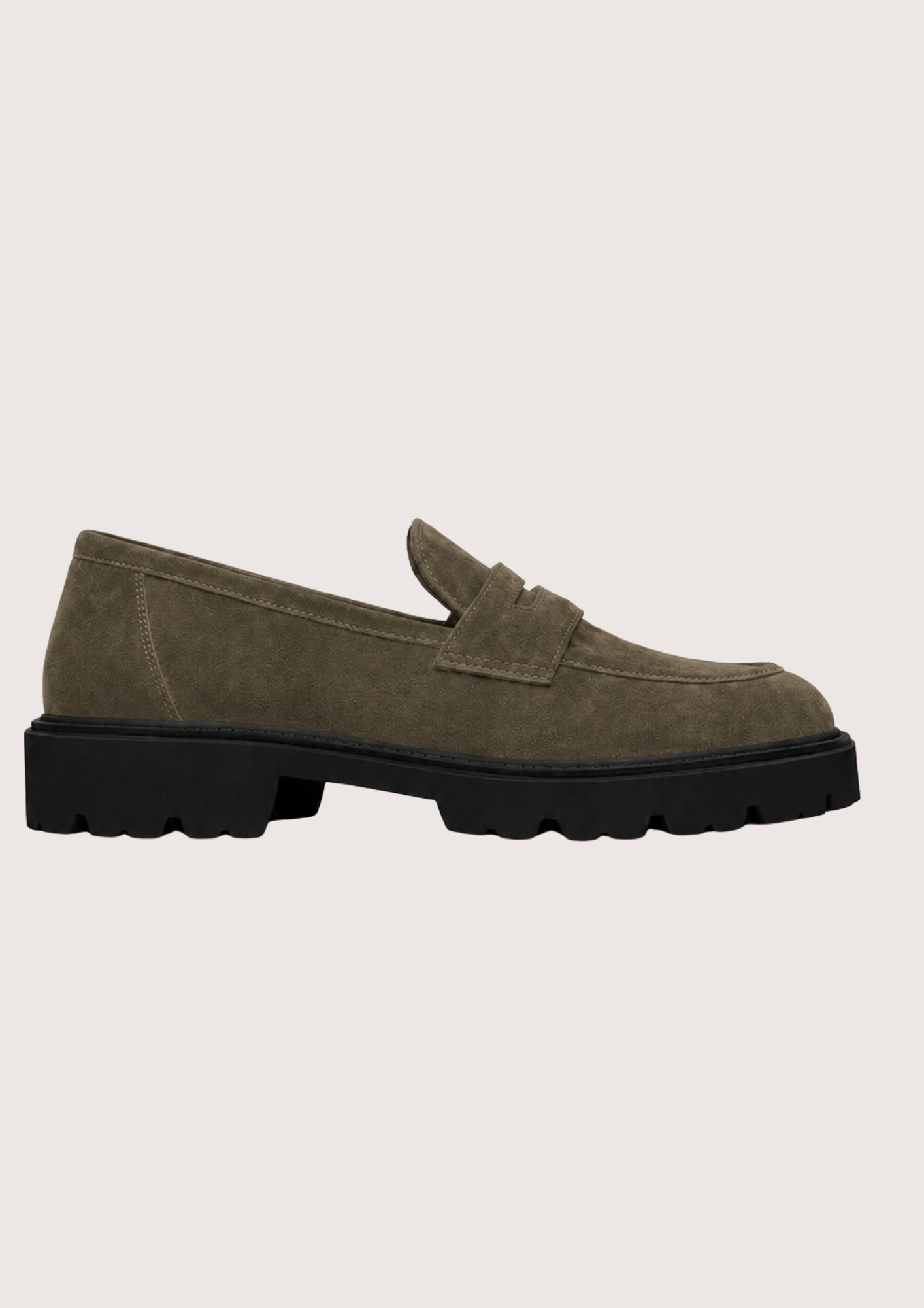 A single khaki suede penny loafer with a chunky black sole, shown in a side profile against a light gray background.