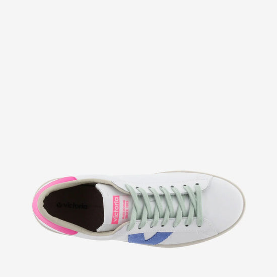 White faux leather trainer with green laces and contrast pink heel tab and suede blue V on outer side